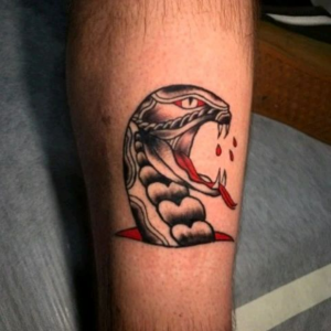 Leg tattoo of black and red snake